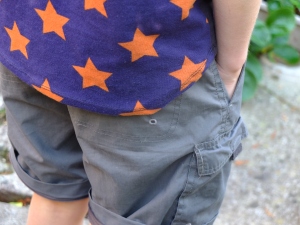 More details (he went and changed into some fairly bright checked shorts with this t shirt after the photo shoot, his taste in clothes is certainly not constrained by convention)